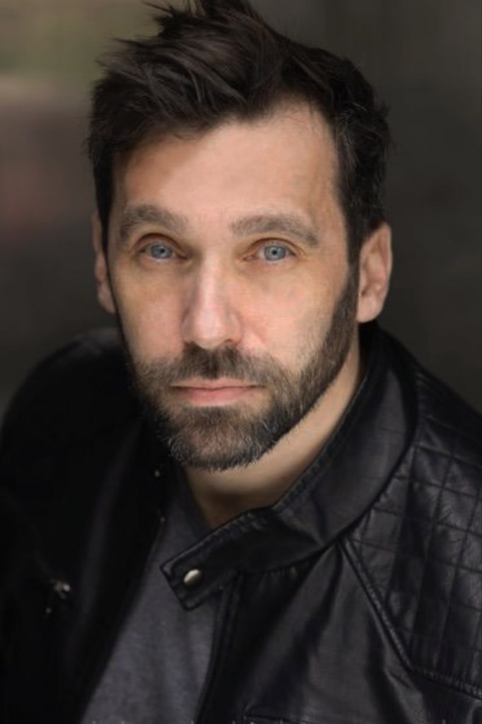 Portrait of James Anderson, author of the One Epic Year trilogy, smiling confidently.